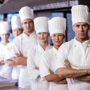 group-of-chefs-standing-in-kitchen-BHK7SNK.jpg